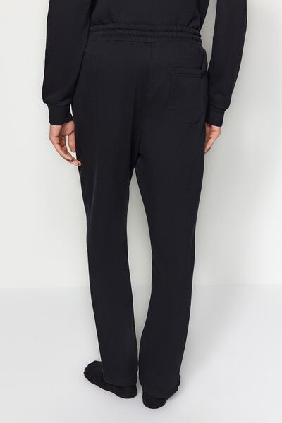 Trendyol Collection Μαύρο κανονικό/κανονικό κομμένο φουσκωτό τύπωμα εσωτερικά φλις/ζεστό παντελόνι φούτερ με ανοιχτό πόδι TMNAW24EA00012