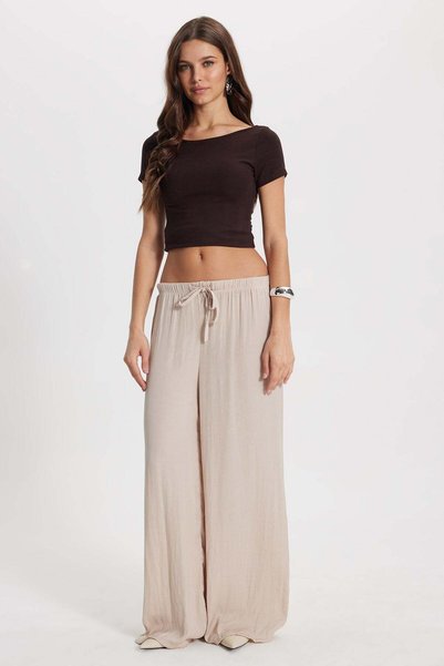 Women's relaxed fit beige trousers with drawstring waist and elasticated wide leg