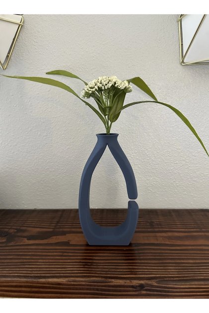Modern black plastic vase with an open frame is perfect for displaying single stems or small