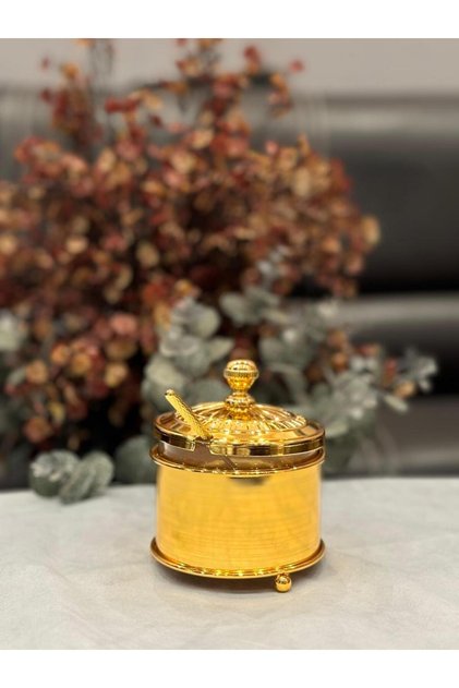 Glass sugar bowl with chrome base and stirring spoon