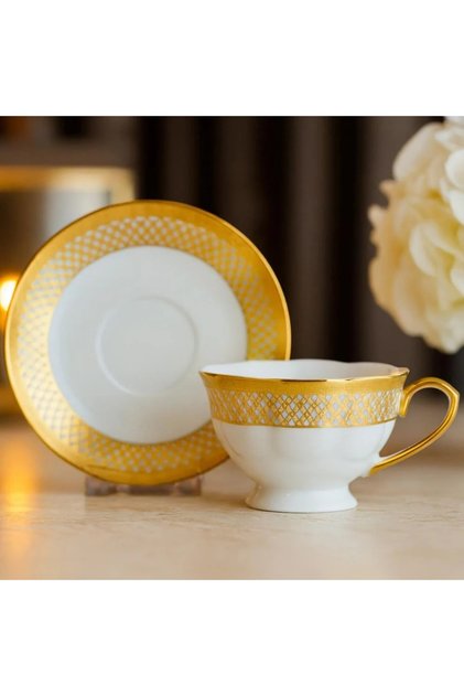 A tea cup set with a porcelain saucer golden decoration