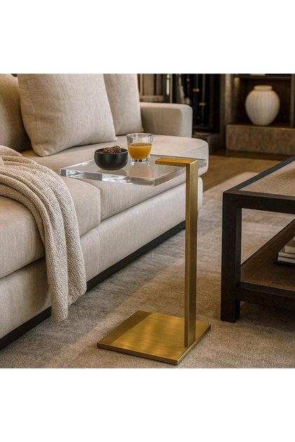A modern side table with an acrylic top and an elegant golden base adds a touch of luxury to the space.