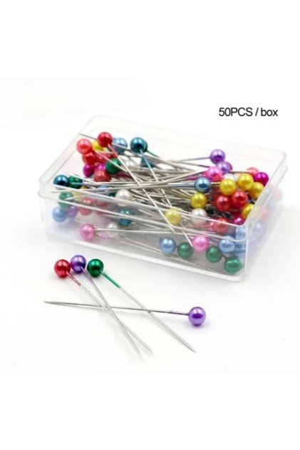 A box of colorful pearl pins