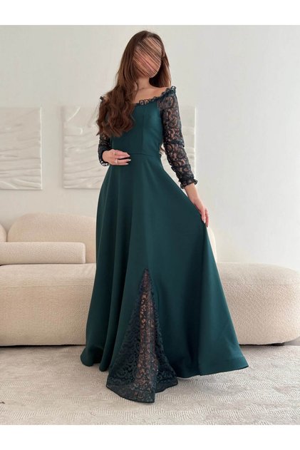 Emerald green dress with French lace sleeves and a regal cut