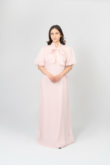 A dress with puffed sleeves and a bow