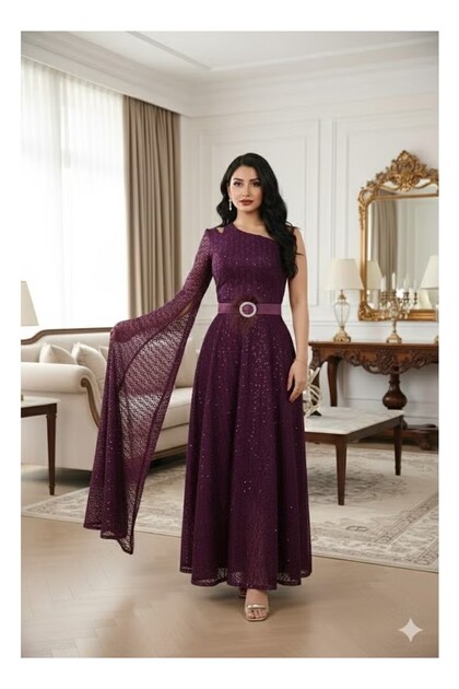 Long evening dress with one wide sleeve and a feathered waist belt; a fashionable dress.