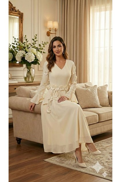 A beige dress with a soft, feminine cut and luxurious touches.