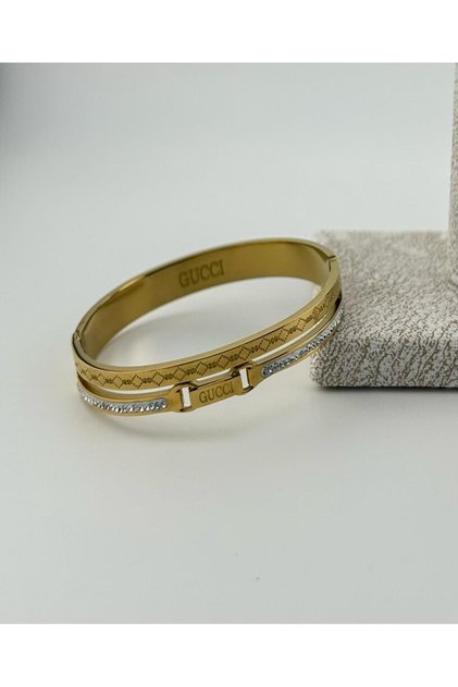 A luxurious gold bracelet with an elegant and distinctive design.