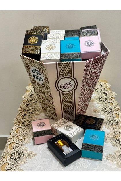 Eid gift sets with various scents of colored musk, 12 pieces, with a tray bearing the phrase "Eid Mubarak".