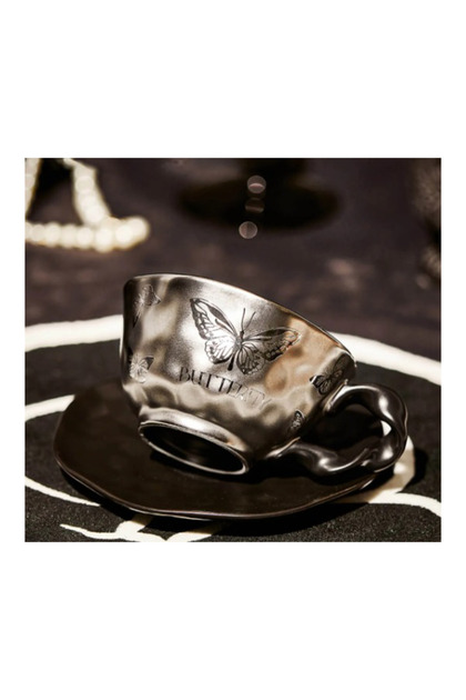 Silver butterfly design coffee mug with saucer - elegant pattern and a touch of luxury.