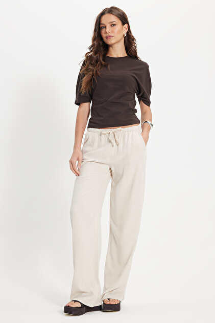 Women's relaxed fit 100% cotton stone washed trousers with drawstring waist, elasticated waistband, double pockets, and a two-thread construction.