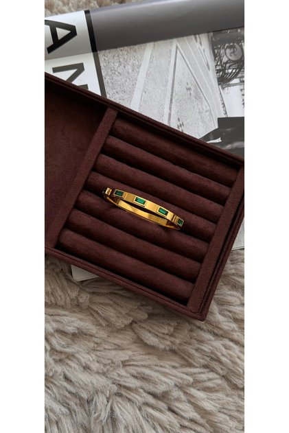 Steel clamp with green stones