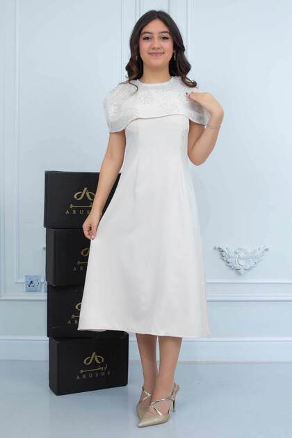 Suad soft beige dress with a distinctive cut .. The confusing age dress