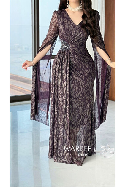 A luxurious purple dress with a delicate pattern and elegant feminine details.