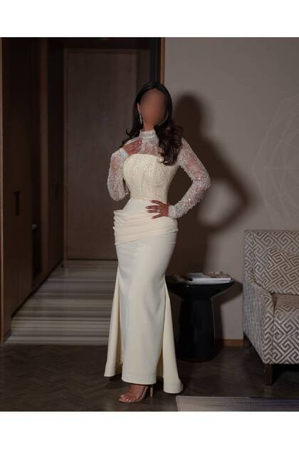 Luxurious Off-White Evening Gown with High Collar, Embroidered Lace Sleeves and a Structured Corset Design.