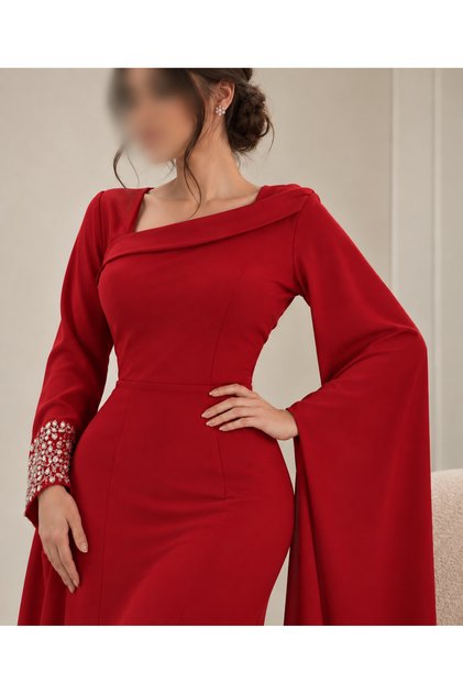 A soft red dress with embellishments on the sleeves