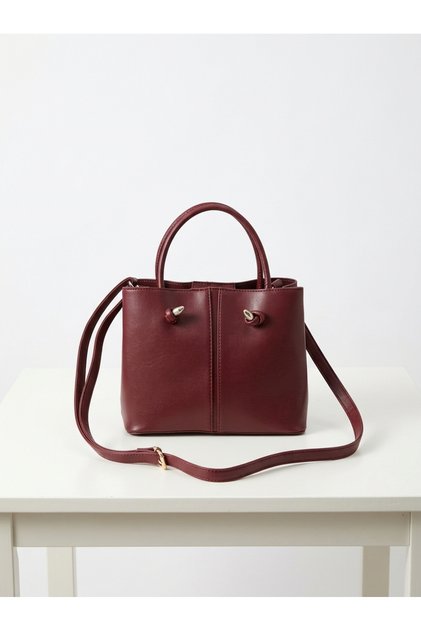 Burgundy knotted handbag/shoulder bag with interior wallet and dual compartments.