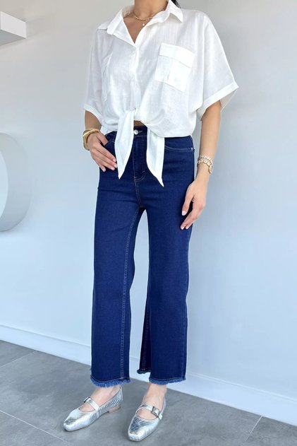 Women's high-waisted denim jeans with tasseled hem