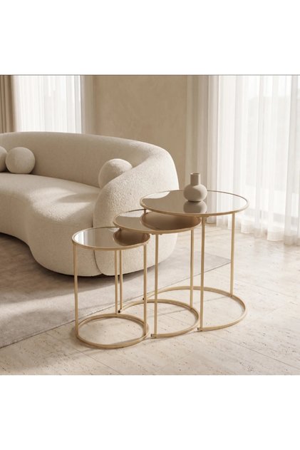 An elegant set of three nesting tables featuring sleek gold-finished metal frames and reflective glass tops.
