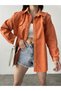 Women's Loose Fit Shirt Jacket with Ripped Detail, Chest Pocket, and Snap Closure.
