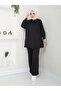 Women's modest outfit with slit hem, zipper detail, and trousers. - 3