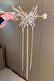 Gold-colored butterfly-shaped hair clip with pearl details and dangling bun shape. - 2