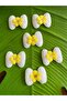 4x3 cm, 6-piece embossed bow/emblem applique sewing accessory, yellow. - 2