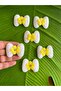 4x3 cm, 6-piece embossed bow/emblem applique sewing accessory, yellow. - 3