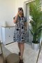 Polo collar shoulder draped labyrinth pattern black dress