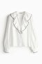 Flounce-trimmed blouse