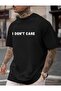 تي شيرت أسود من القطن الممشط مطبوع عليه عبارة I Dont Care