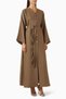 Reflect elegance with the waist-detailed buttoned abaya that suits every occasion.