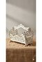 A white wooden basket for fruit, magazines, or other uses.