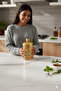 A set of three different-sized acrylic containers for storing spices, legumes, and sugar, in a gold color. - 6