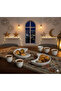 A luxurious Ramadan hospitality set consisting of 12 pristine white ceramic coffee cups and two serving saucers. - 4