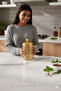 A set of three different-sized acrylic containers for storing spices, legumes, and sugar, in a gold color. - 5