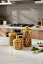 A set of three different-sized acrylic containers for storing spices, legumes, and sugar, in a gold color. - 3