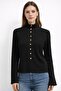 Women's black knit sweater with stand collar and gold snap detail