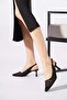 Loles black patent leather women's heeled shoes with open back, mesh detail, and drawstring closure.