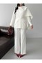 Elegant and Wide-Leg Pants with a Draped Shawl Detail on the Blazer Jacket.