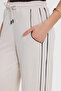 Women's relaxed fit beige trousers with drawstring waist, elasticated stripes, and double pockets. - 3