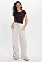 Women's relaxed fit beige trousers with drawstring waist, elasticated stripes, and double pockets. - 7