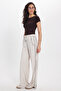 Women's relaxed fit beige trousers with drawstring waist, elasticated stripes, and double pockets. - 4