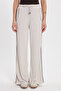 Women's relaxed fit beige trousers with drawstring waist, elasticated stripes, and double pockets.