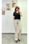 High-Waisted, Elastic-Waisted, Buttoned, Spanish-Style Flared Pants with Pockets on Both Sides and Back.