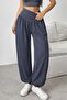 Women's high-waisted, wide-leg viscose pants with drawstring waist and pockets.