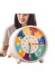 This children's alarm clock helps children learn to tell time. It features a colorful dial, silent operation, and is battery powered. - 3