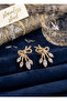 Rice gold color zircon stone bow model earrings.