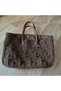 Hand-Knitted Oval Base Shoulder Bag with String on Brown Paper. - 4