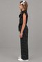 Girl's Black Jumpsuit with Ruffle Detail on the Collar and Shoulders and Polka Dots All over - 4